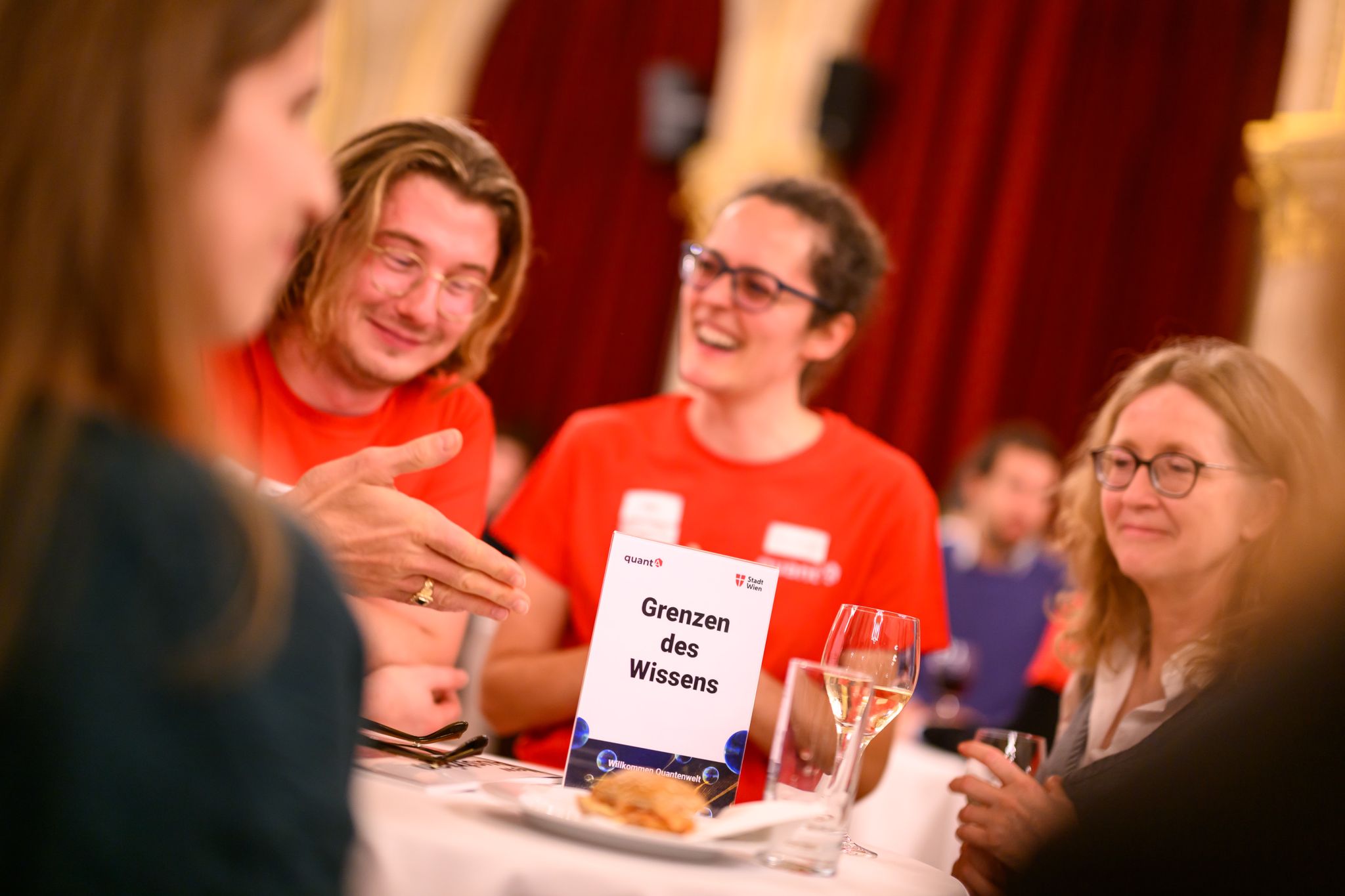 Quantum researchers chatting at the designated info points with the public after the event 