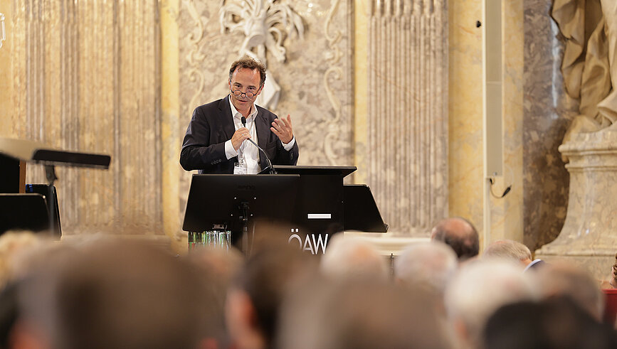 Markus Aspelmeyer at the podium, giving a lecture at the Austrian Academy of Sciences
