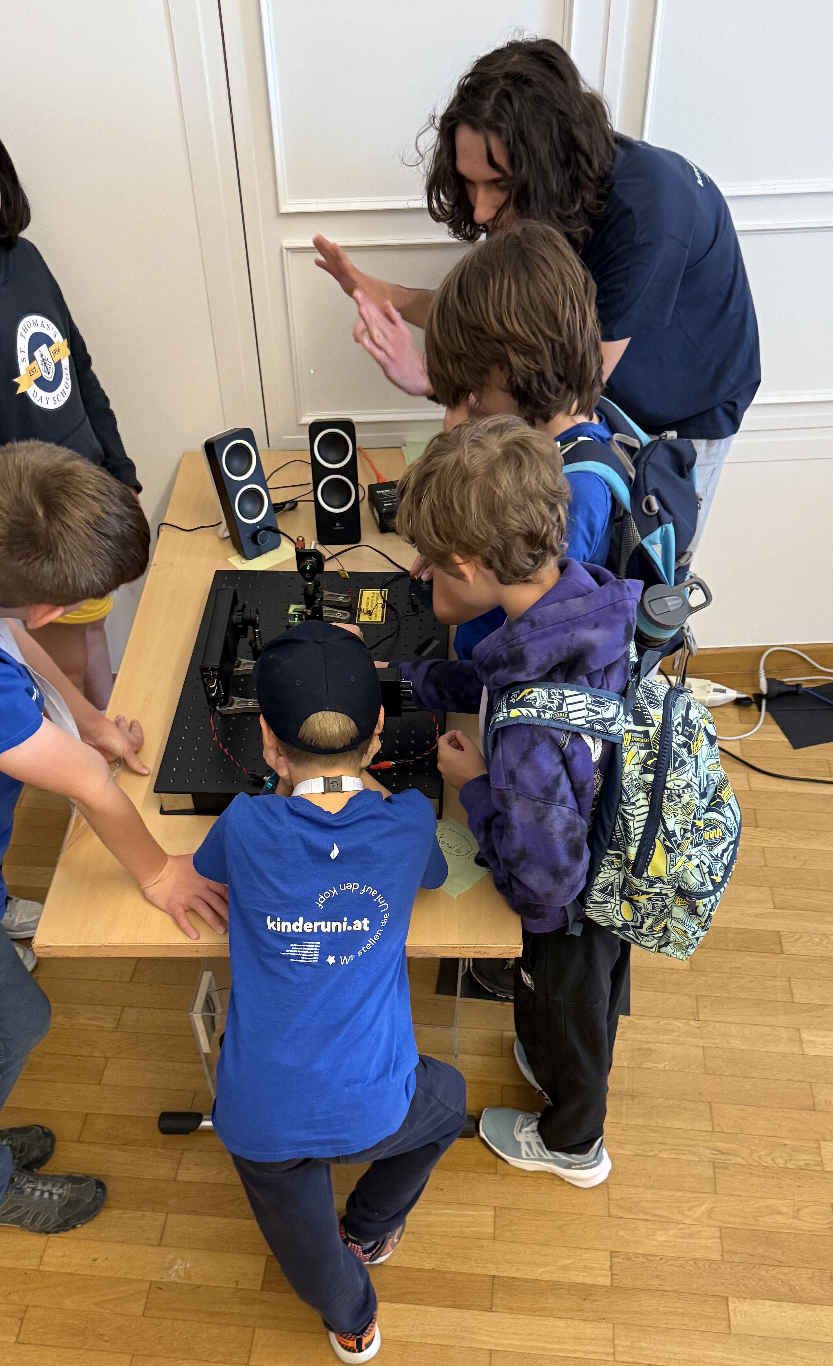 A researcher showing an experiment to a small group of children
