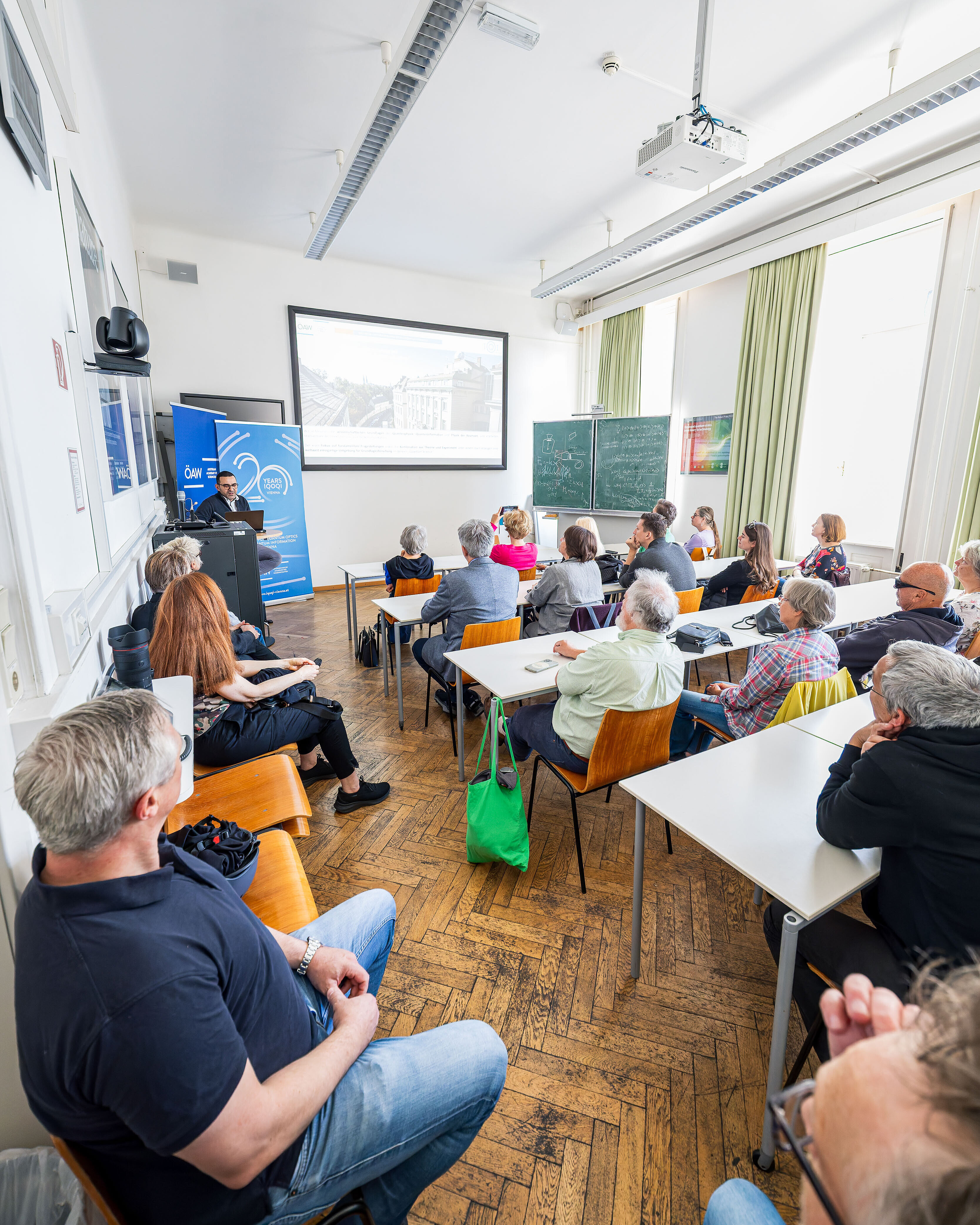 a full seminar room with an ongoing presentation